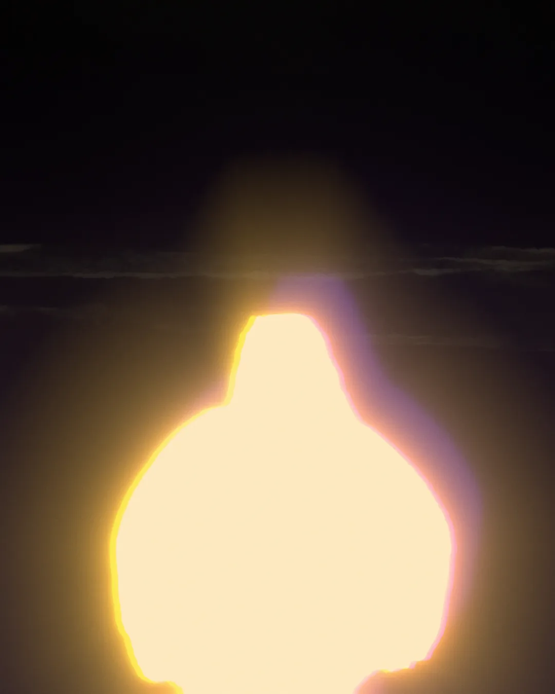 A figure blown out into a warm, glowing light against a dark room in Glow’s Retro look